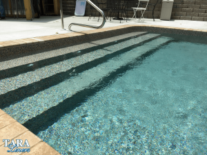 Inground pool with tan liner, showing how the water looks more blue as pool gets deeper