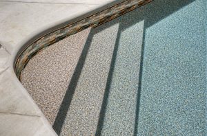 Pool stairs featuring a tan pebble liner